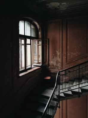black and brown stairs beside window